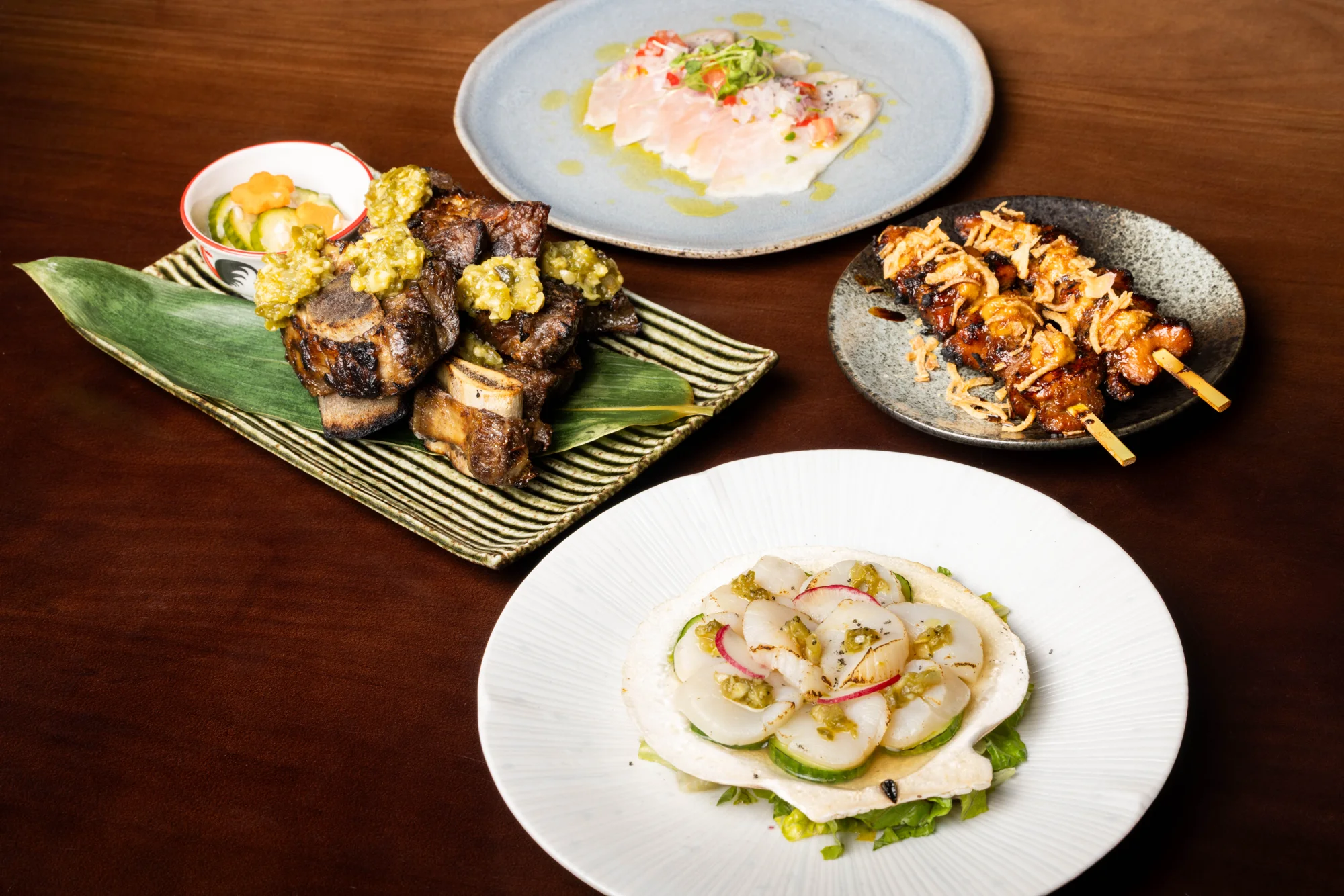 Hamachi, scallops, beef ribs and sate served together